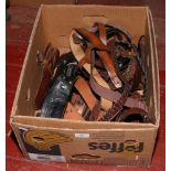 A box of leather gun holsters.
