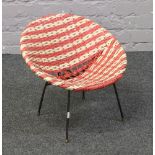 A 1960s red and white wicker child's chair.
