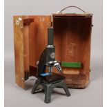 A microscope in wooden case, maker A C. Baker, serial 8442.