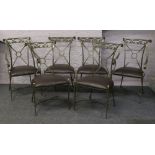 A set of six painted green wrought iron dining chairs with upholstered seats including two carvers.