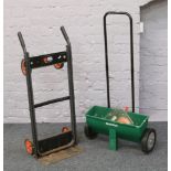 A Black & Decker 100kg sack barrow along with a Qual cast lawn food spreader.