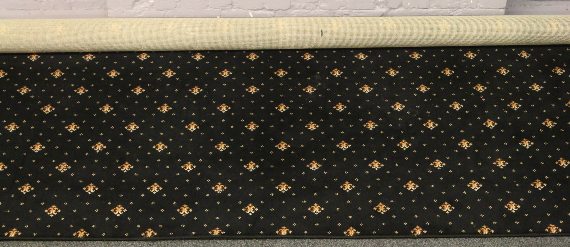 A black ground Axminster carpet square with gold decoration, 367cm x 420cm.