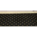 A black ground Axminster carpet square with gold decoration, 367cm x 420cm.