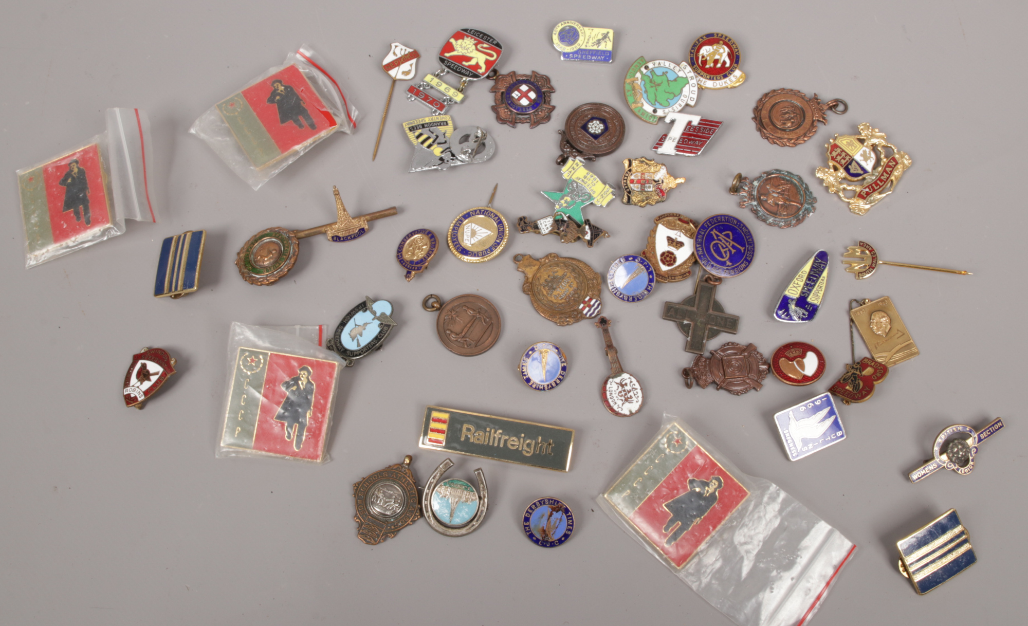 A box of various medals and badges to include enamel examples.