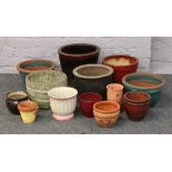 A quantity of planters including terracotta glazed and concrete examples.