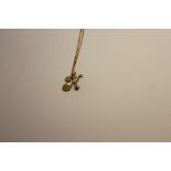 Gilt metal 'K' pendant, set with white stone, 9ct gold chain