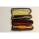 18ct gold mounted cheroot holder, silver mounted cheroot holder (both cased)