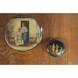 Two Russian papier mache snuff boxes, the larger with couple outside a doorway, the smaller with