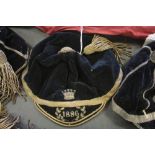 Late 19th Century black velvet and gilt brocade sporting cap, with tassel, embroidered coronet style