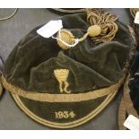 Early 20th Century green velvet and gilt brocade sporting cap, with tassel, with embroidered crest