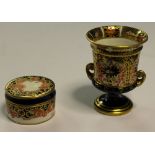 Two Royal Crown Derby bone china items - miniature two handled urn (date code 1918) and lidded