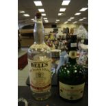 Large Bells whiskey bottle and green Cognac bottle