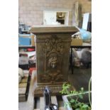 Large cast iron plinth with cherubs and masks