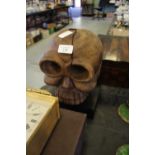 Wooden skull on plinth