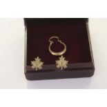 Pair of 9ct gold stud earrings in the shape of a maple leaf and a single gold earring