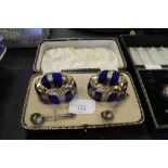 A pair of cased gilt and cobalt glass salts