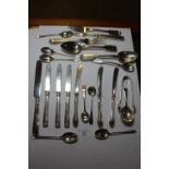 Silver spoons, tongs, forks, and silver handled knives