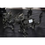 Pair of dark brown patinated bronze candlesticks of 'Chinese Dragon' design