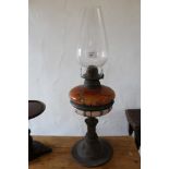 Victorian table oil lamp with coloured glass reservoir and coppered base, with chimney