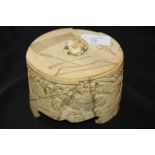 Antique Japanese ivory oval lidded box, the sides carved in relief with warring soldiers, the lid