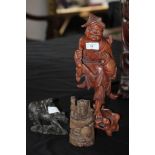 Chinese carved and stained wood figure of a Fisherman, a ditto carving of a figure astride a water