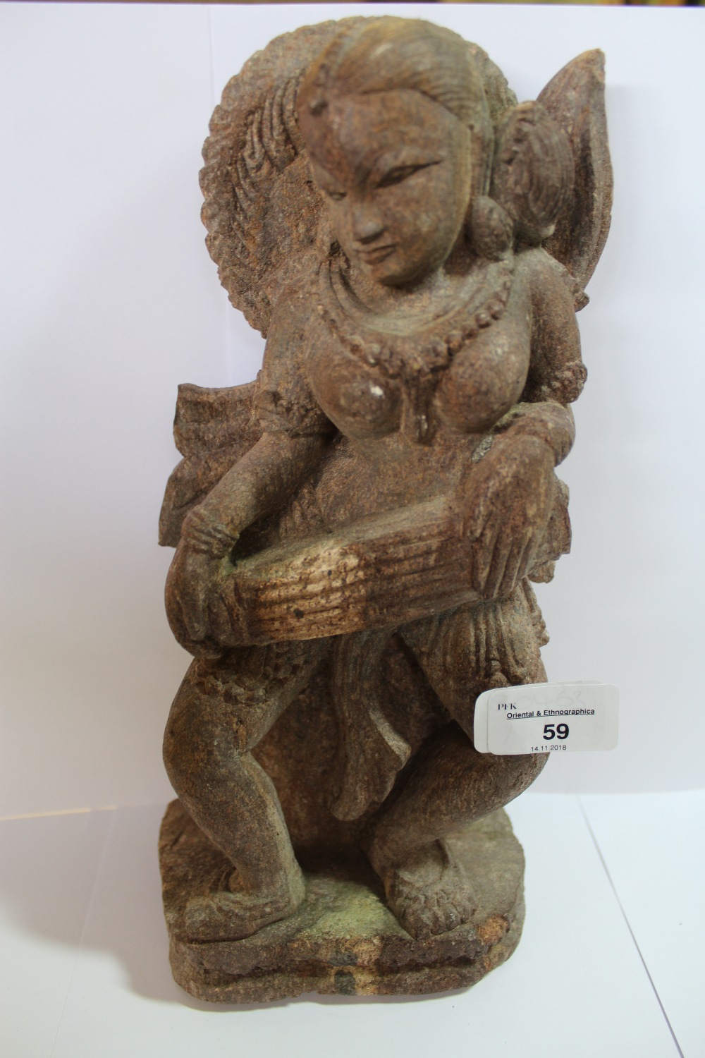 Carved Stone Indian Deity Playing a Musical Instrument