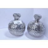 Pair of Victorian embossed and gadrooned silver table scent bottles and covers by George Unite,