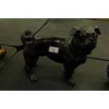 Black glazed stoneware figure of a Pug dog, with glass eyes, 26cm high