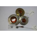 Three Scottish plated amber glass brooches and a silver miniature axe brooch