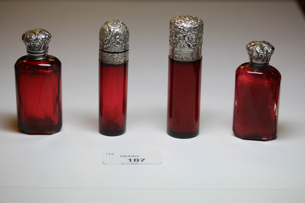 Two Victorian white metal (thought silver) topped ruby glass cylindrical scent bottles, both with