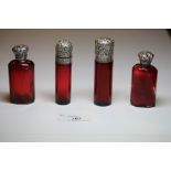 Two Victorian white metal (thought silver) topped ruby glass cylindrical scent bottles, both with