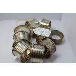 Set of four George V silver napkin rings, London 1919 and six other silver napkin rings