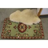 Sheepskin rug and one other