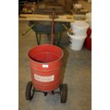 Metal grass seed spreader and wheelbarrow