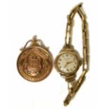 Gold 9ct presentation medal and a gold cased lady's watch. No condition reports for this sale.
