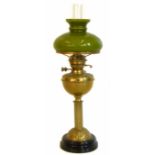 Victorian brass column oil lamp complete with shade. No condition reports for this sale.
