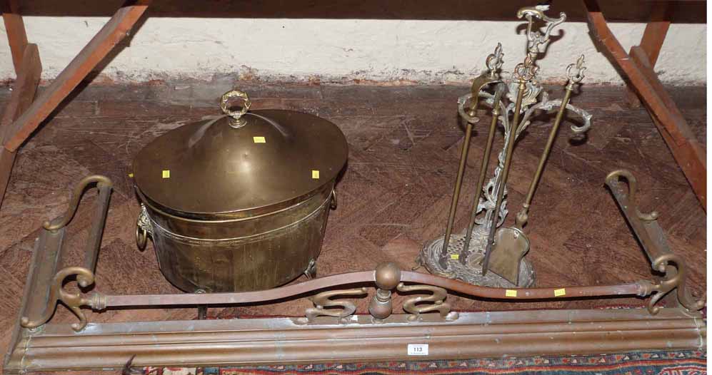An Edwardian brass oval coal bucket, A copper and brass kerb and a brass hearth tidy No condition