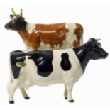 Beswick Ayrshire cow and Fresian cow. No condition reports for this lot.