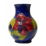 A Moorcroft vase decorated with a hibiscus pattern. No condition reports for this lot.