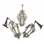 Two wrought iron bracket lanterns and one pendant lantern. With curlicue metalwork.