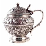 Georgian circular silver mustard pot, embossed with leaf and floral decoration, hinged domed lid