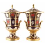 Pair of Caverswall lidded twin handle vases, decorated with Romany pattern in a Crown Derby Imari