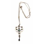 An Edwardian 9ct gold aquamarine and seed pearl set drop pendant, the Art Nouveau scrollwork