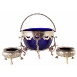 Continental openwork silver basket with blue glass liner on four scrolling foliate feet, also with