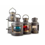 Four steel ships lanterns for port, starboard, anchor and stern. The latter bears the anchor mark of