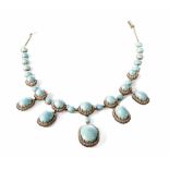 A turquoise and diamond cluster 5-drop collarette necklace comprising 5 oval cabochon cut turquoise,