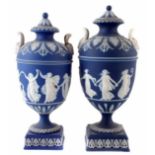 Two Wedgwood vases blue jasper dip twin handled lidded vases, decorated with dancing hours,