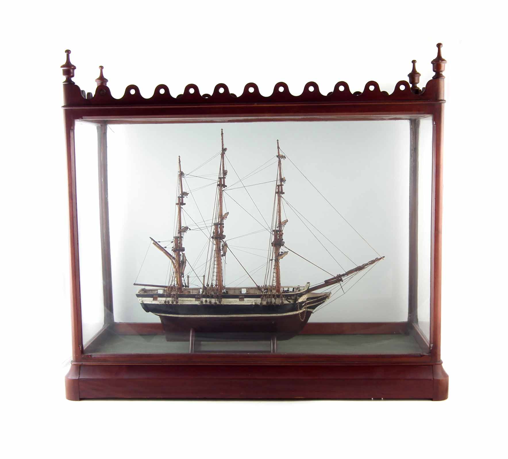 Cased glass ship, fitted in a good Victorian mahogany display case with pierced cornice and turned