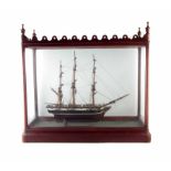 Cased glass ship, fitted in a good Victorian mahogany display case with pierced cornice and turned