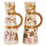 Pair of Royal Worcester ewers, with moulded blossom details, decorated with flora on an ivory